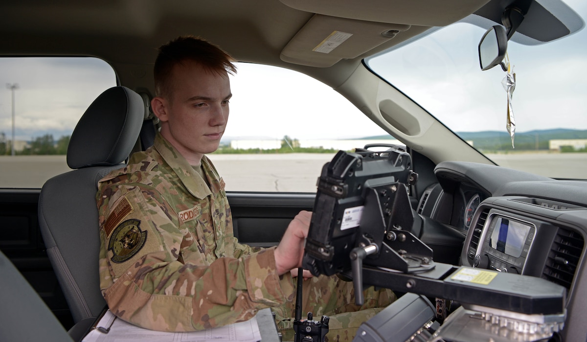 U.S. Air Force Senior Airman Zachary Rodgers, 354th Operations Support Squadron Airfield Management Flight shift lead, uses a computer in his vehicle during RED FLAG-Alaska 21-2 on Eielson Air Force Base, Alaska, June 21, 2021. In addition to keeping the airfield safe, airfield management Airmen also manage the airfield driving program, ensuring people who drive on the airfield are qualified and know what they are doing, and log flight plan data to keep an accurate record of flying hours. (U.S. Air Force photo by Senior Airman Beaux Hebert)