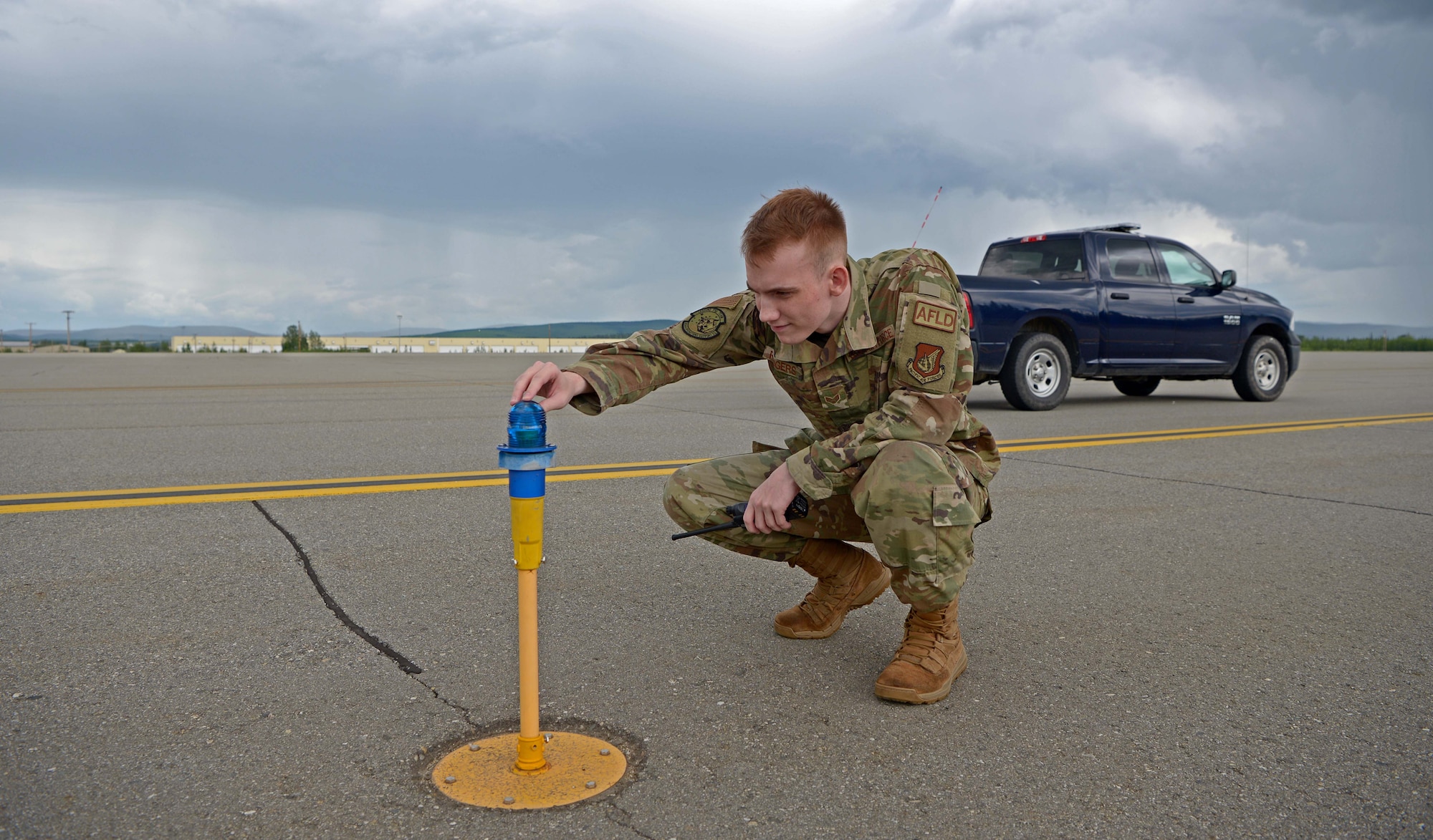 U.S. Air Force Senior Airman Zachary Rodgers, 354th Operations Support Squadron Airfield Management Flight shift lead, inspects an airfield light during RED FLAG-Alaska 21-2 on Eielson Air Force Base, Alaska, June 21, 2021. Rodgers’ responsibilities include checking the airfield for debris, damage, and wildlife, and ensuring all runway lights are functioning. (U.S. Air Force photo by Senior Airman Beaux Hebert)