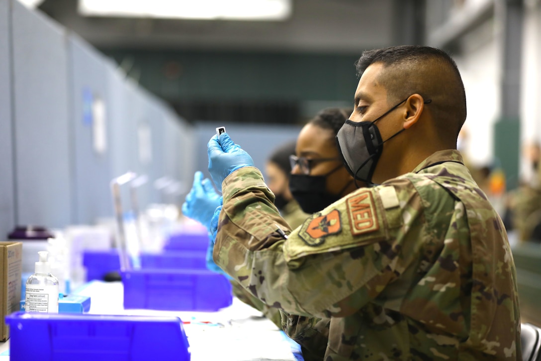 U.S. Air Force Staff Sgt. Gabriel Martinez, an Odessa, Texas, native and medical technician assigned to the 59th Medical Wing, prepares COVID-19 vaccine at the state-run, federally-supported COVID-19 Community Vaccination Center at the New Jersey Institute of Technology, April 1, 2021.