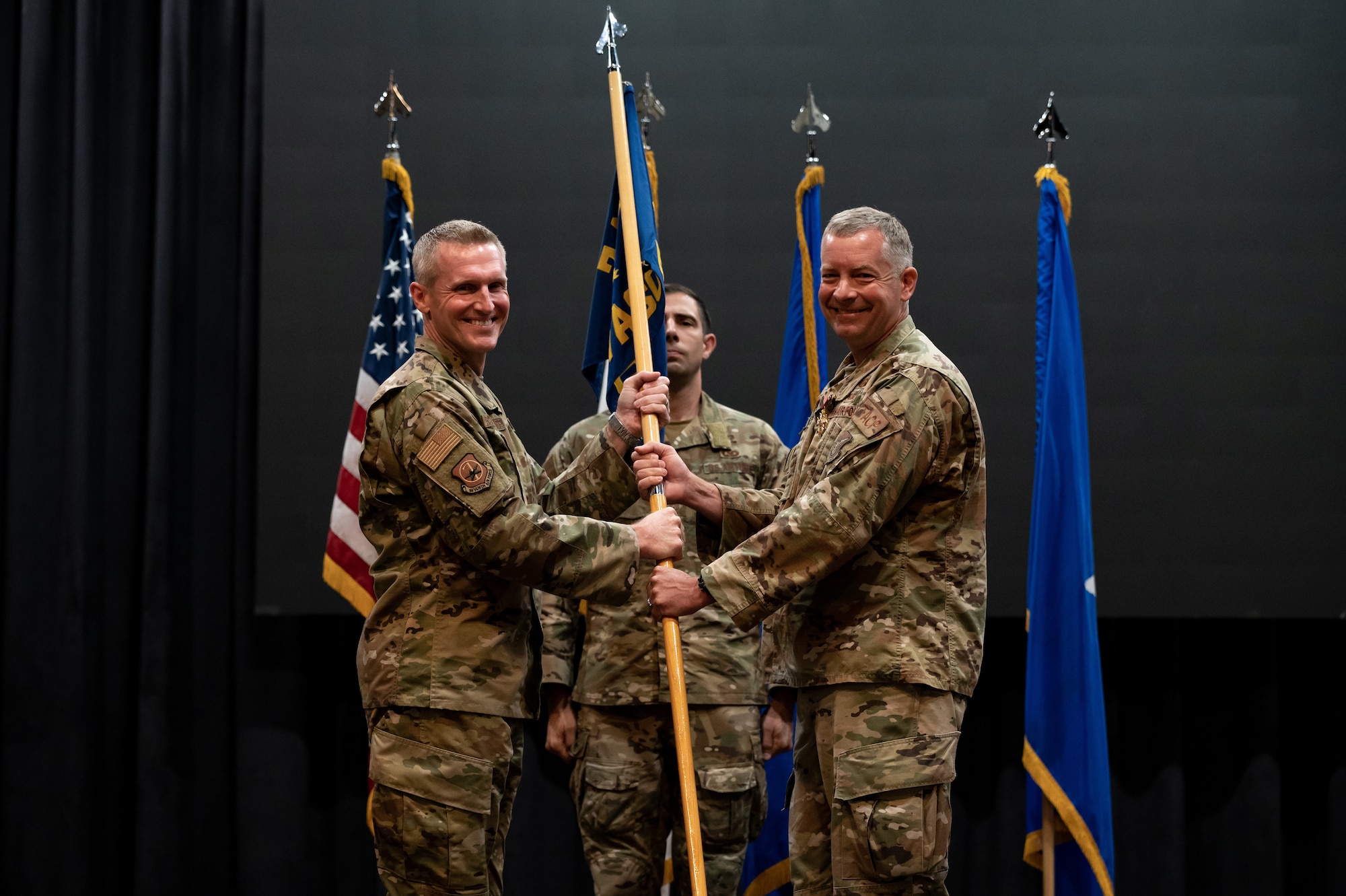 Brig. Gen. Jason Rueschhoff, 7th Air Force deputy commander, left, receives the ceremonial guidon from Col. William Edmunds, 607th Air Support Operations Group outbound commander, at Osan Air Base, Republic of Korea, June 22, 2021. This act marks the official end of Edmunds tenure as commander of the 607th ASOG. (U.S. Air Force photo by Tech. Sgt. Nicholas Alder)