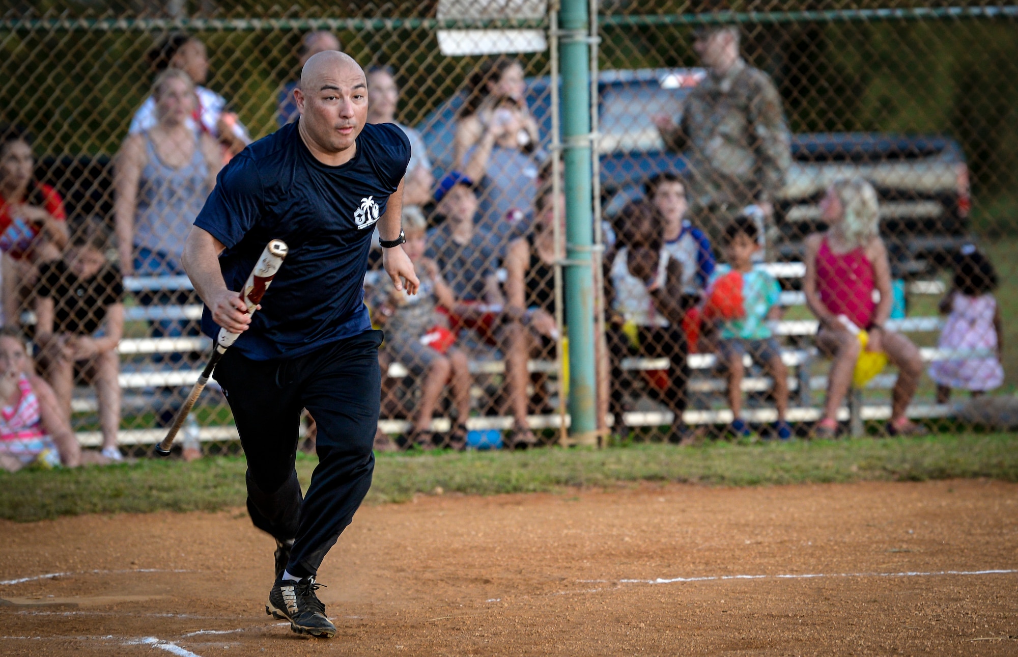 U.S. Air Force Chief Master Sgt. John Payne, 36th Wing command chief, runs to first base during the Chief’s versus Eagle’s softball game at Andersen Air Force Base, Guam, June 18, 2021.