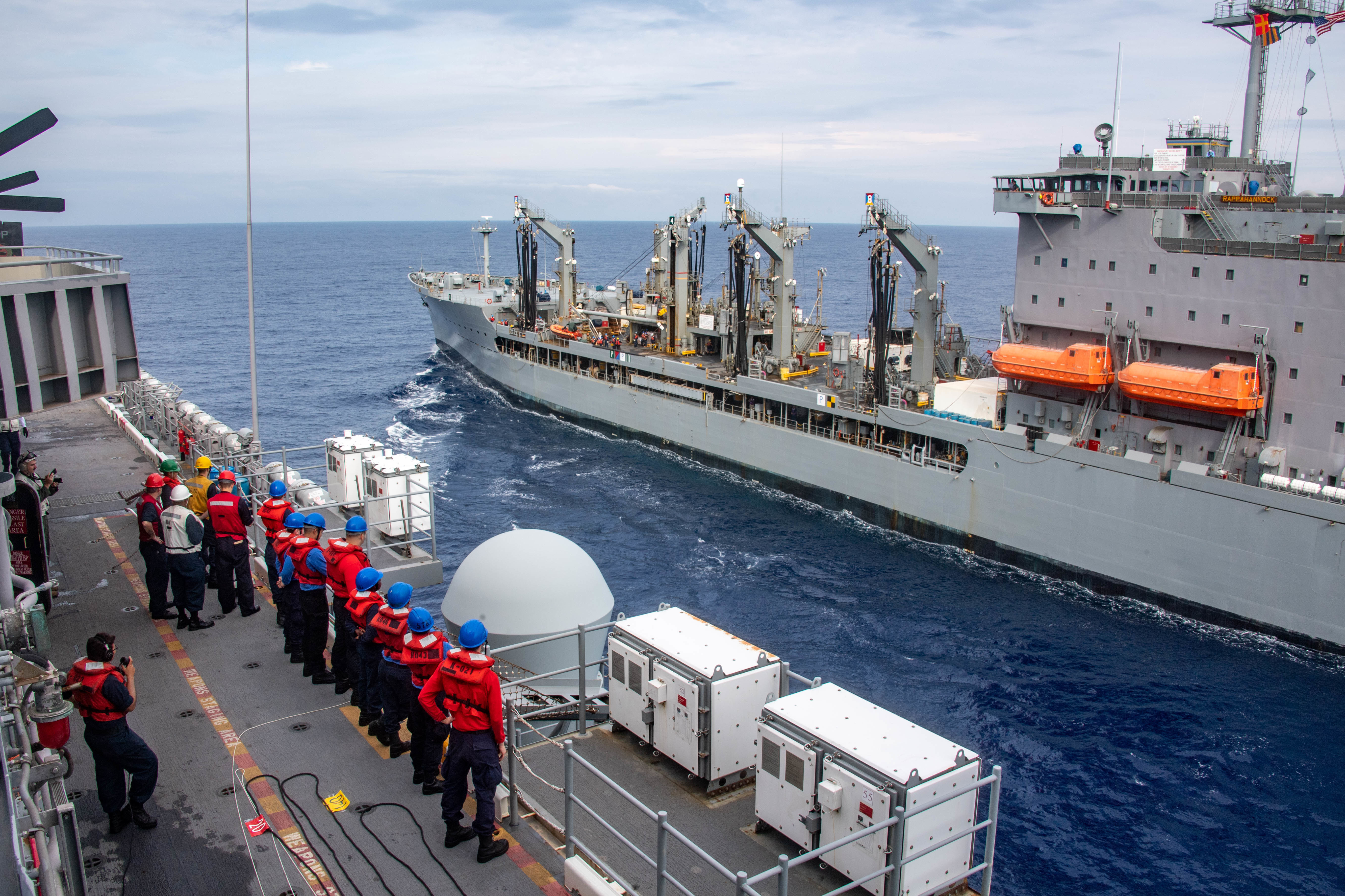 The forward-deployed amphibious assault ship USS America (LHA 6) sails alongside the fleet replenishment oiler USNS Rappahannock (T-AO 204) during a replenishment-at-sea.