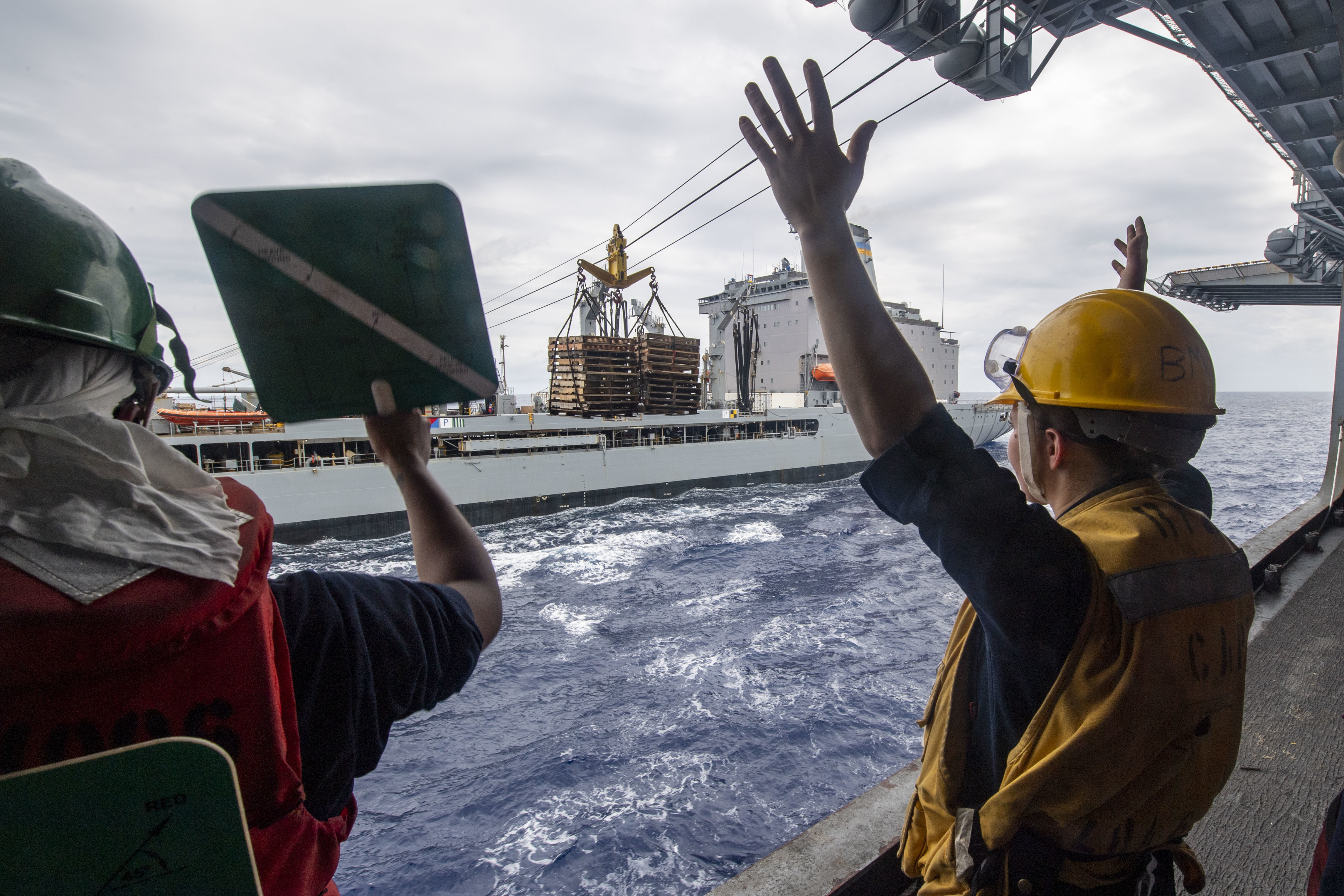 Sailors assigned to the forward-deployed amphibious assault ship USS America (LHA 6) participate in a replenishment-at-sea with the fleet replenishment oiler USNS Rappahannock (T-AO 204).