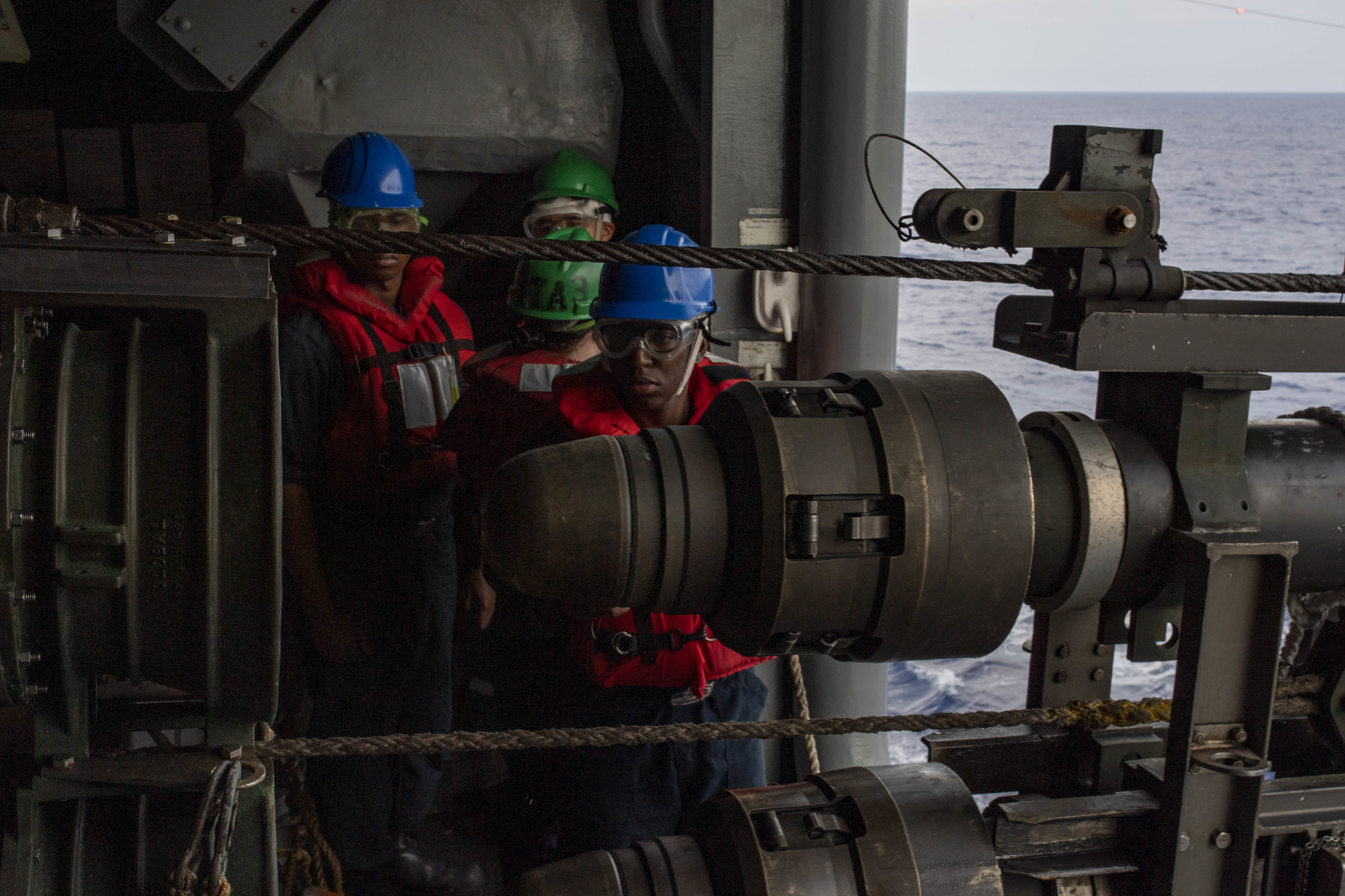 Sailors assigned to the forward-deployed amphibious assault ship USS America (LHA 6) ensure a proper seating of the fuel hose during a replenishment-at-sea with USNS Rappahannock (T-AO 204).