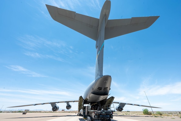 Airmen from the 49th Logistics Readiness Squadron load a K-loader onto a Dover Air Force Base C-5M Super Galaxy during a Major Command Service Tail Trainer exercise at Holloman AFB, New Mexico, June 9, 2021. During the training exercise, Airmen loaded and unloaded 320,085 pounds of cargo, including palletized cargo, aircraft ground equipment, a fuel truck and a K-loader. (U.S. Air Force photo by Senior Airman Faith Schaefer)