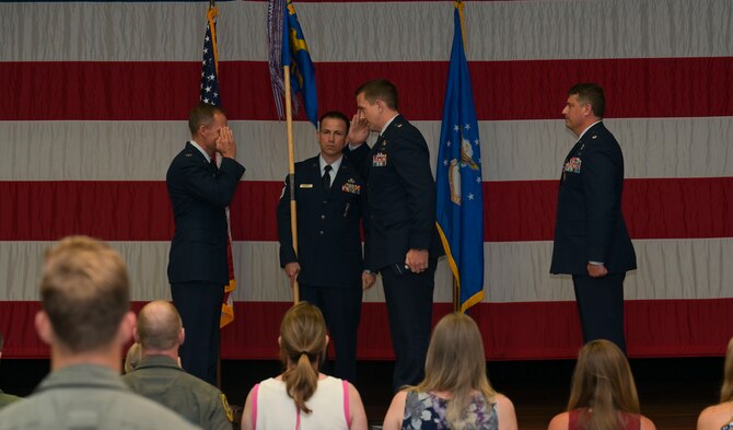 U.S. Air Force Col. Justin Spears, 14th Operations Group commander, Lt. Col. Courtland Stanley, incoming 14th Student Squadron commander, and Lt. Col. Joseph McCane, outgoing 14th STUS commander, pass the guidon,  during a the 14th STUS Change of Command ceremony, June 21, 2021, on Columbus Air Force Base, Miss. The 14th Student Squadron ranks as the largest squadron at Columbus AFB, consisting of 21 active duty and 82 civilian permanent party personnel as well as approximately 700 student pilots from 25 different nations. (U.S. Air Force photo by Airman 1st Class Jessica Haynie)