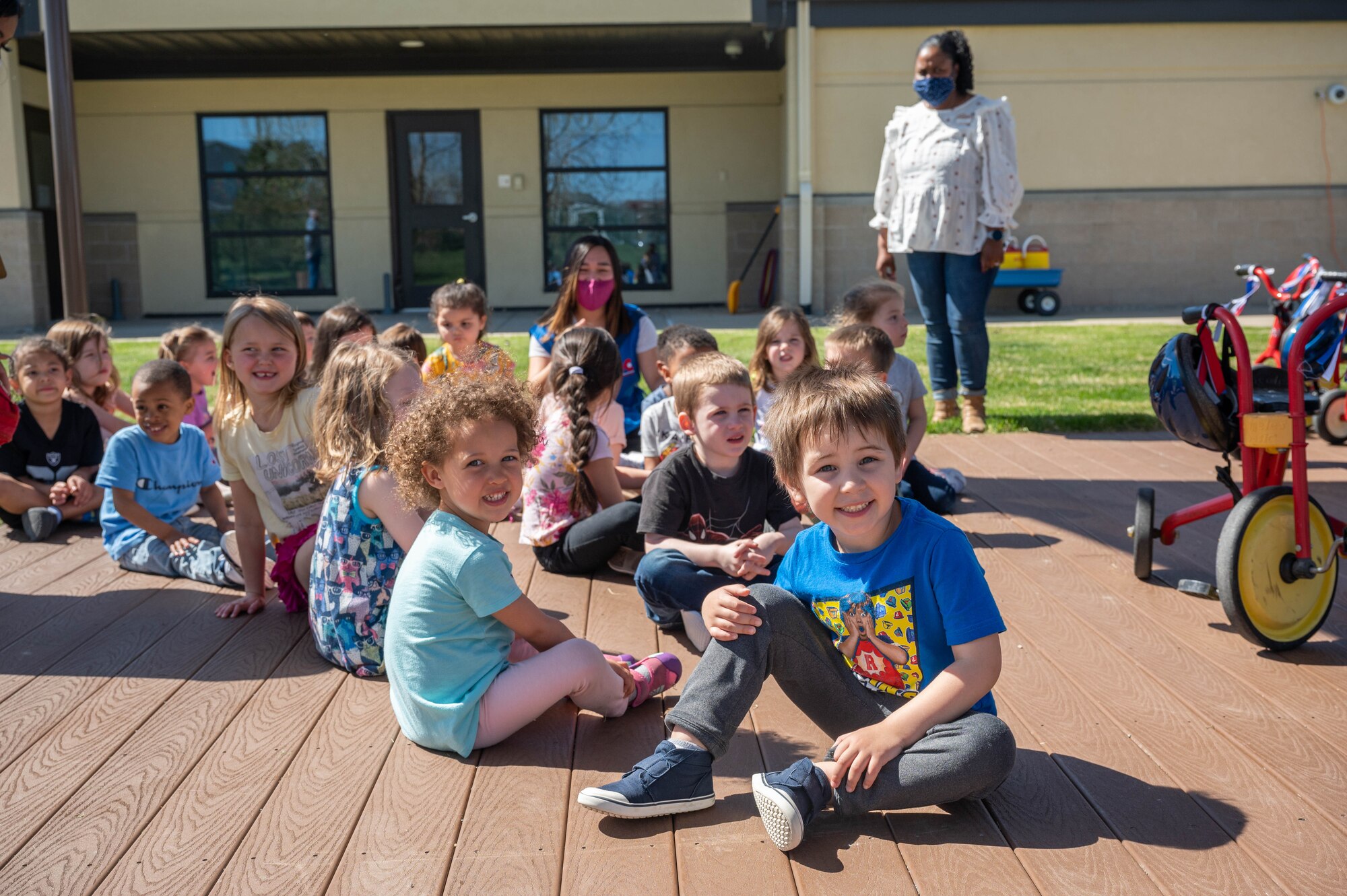 Children sit in a playground.