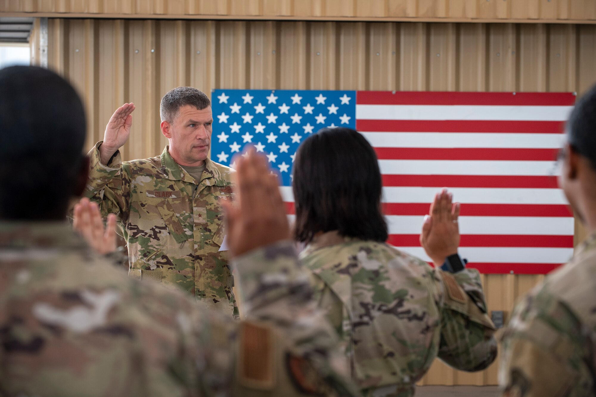 U.S. Air Force Brig. Gen. Andrew Clark, 380th Air Expeditionary Wing commander, administers an oath to the Teal Team 6 (TT6) volunteer members during the Sexual Assault Prevention and Response (SAPR), TT6 induction ceremony at Al Dhafra Air Base (ADAB) United Arab Emirates, June 18, 2021. TT6 members, take an oath to uphold a code of ethics, promote mutual respect, to support others and promise to improve the culture around them.