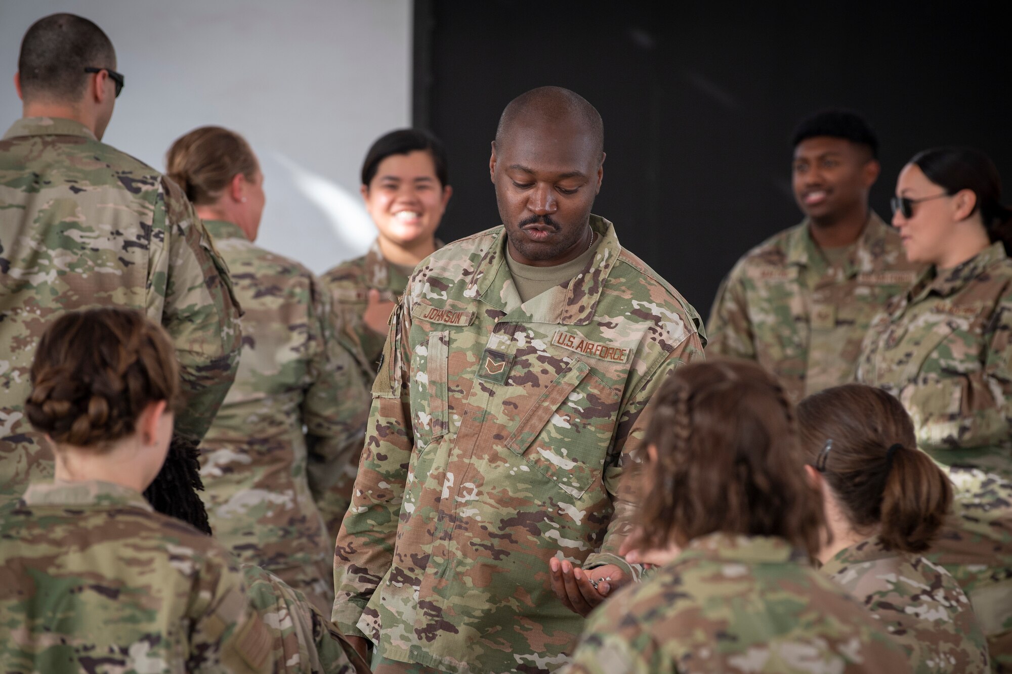 U.S. Air Force Brig. Gen. Andrew Clark, 380th Air Expeditionary Wing commander, administers an oath to the Teal Team 6 (TT6) volunteer members during the Sexual Assault Prevention and Response (SAPR), TT6 induction ceremony at Al Dhafra Air Base (ADAB) United Arab Emirates, June 18, 2021. TT6 members, take an oath to uphold a code of ethics, promote mutual respect, to support others and promise to improve the culture around them.