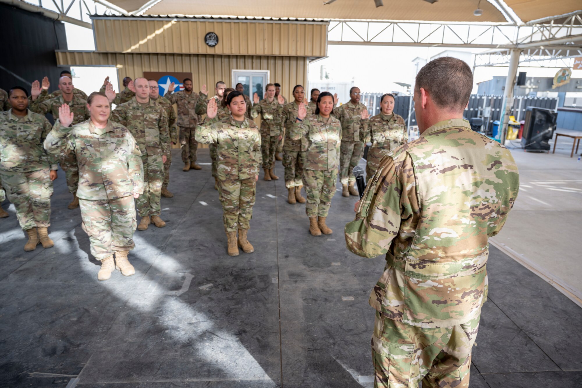 U.S. Air Force Brig. Gen. Andrew Clark, 380th Air Expeditionary Wing commander, administers an oath to the Teal Team 6 (TT6) volunteer members during the Sexual Assault Prevention and Response (SAPR), TT6 induction ceremony at Al Dhafra Air Base (ADAB) United Arab Emirates, June 18, 2021. TT6 members, take an oath to uphold a code of ethics, promote mutual respect, to support others and promise to improve the culture around them.