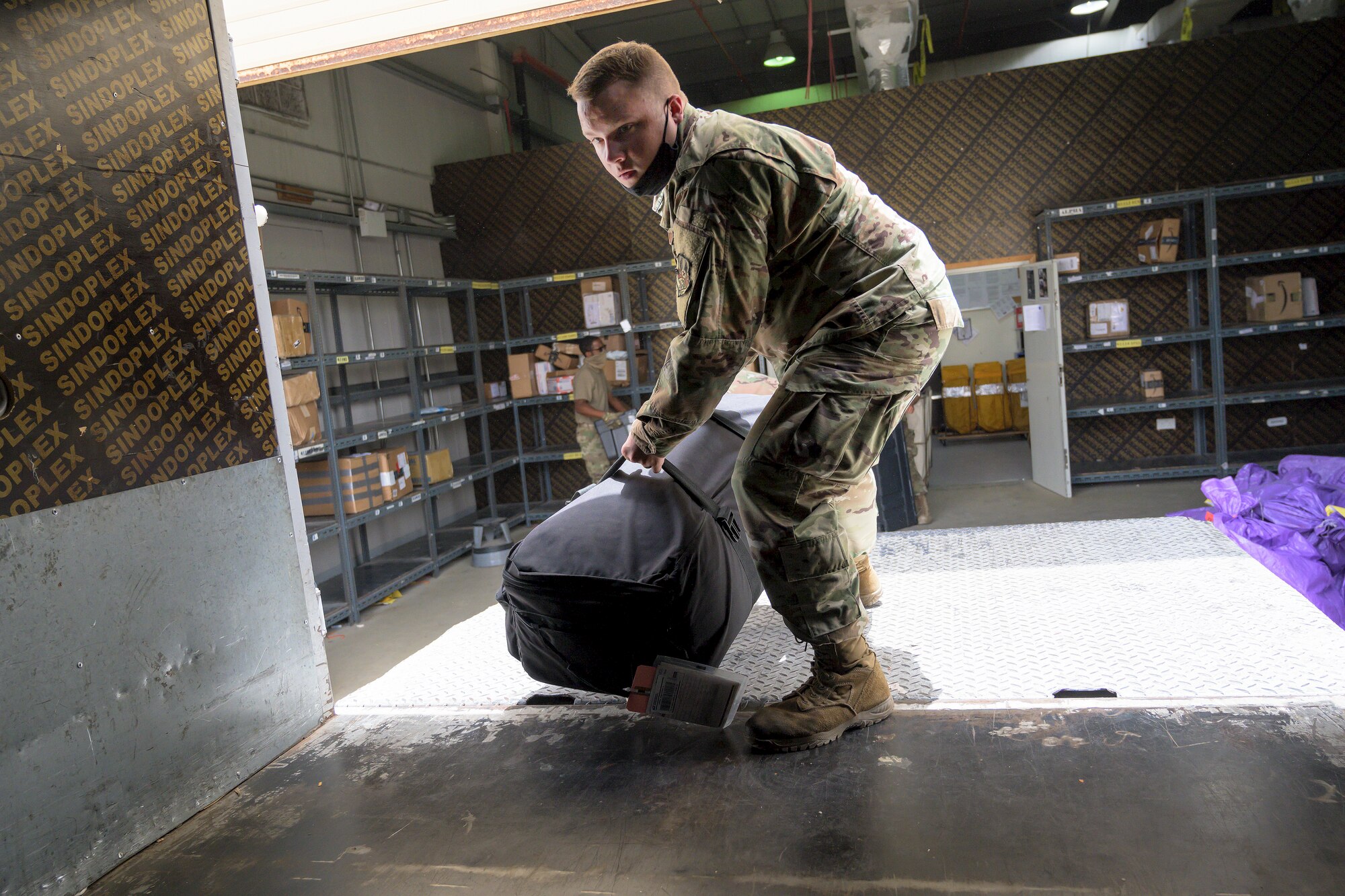 U.S. Air Force Airmen from the 380th Expeditionary Force Support Squadron, sort mail packages at Al Dhafra Air Base (ADAB), United Arab Emirates, June 16, 2021. The ADAB post office averages 52,000 lbs across 8,500 packages a month.