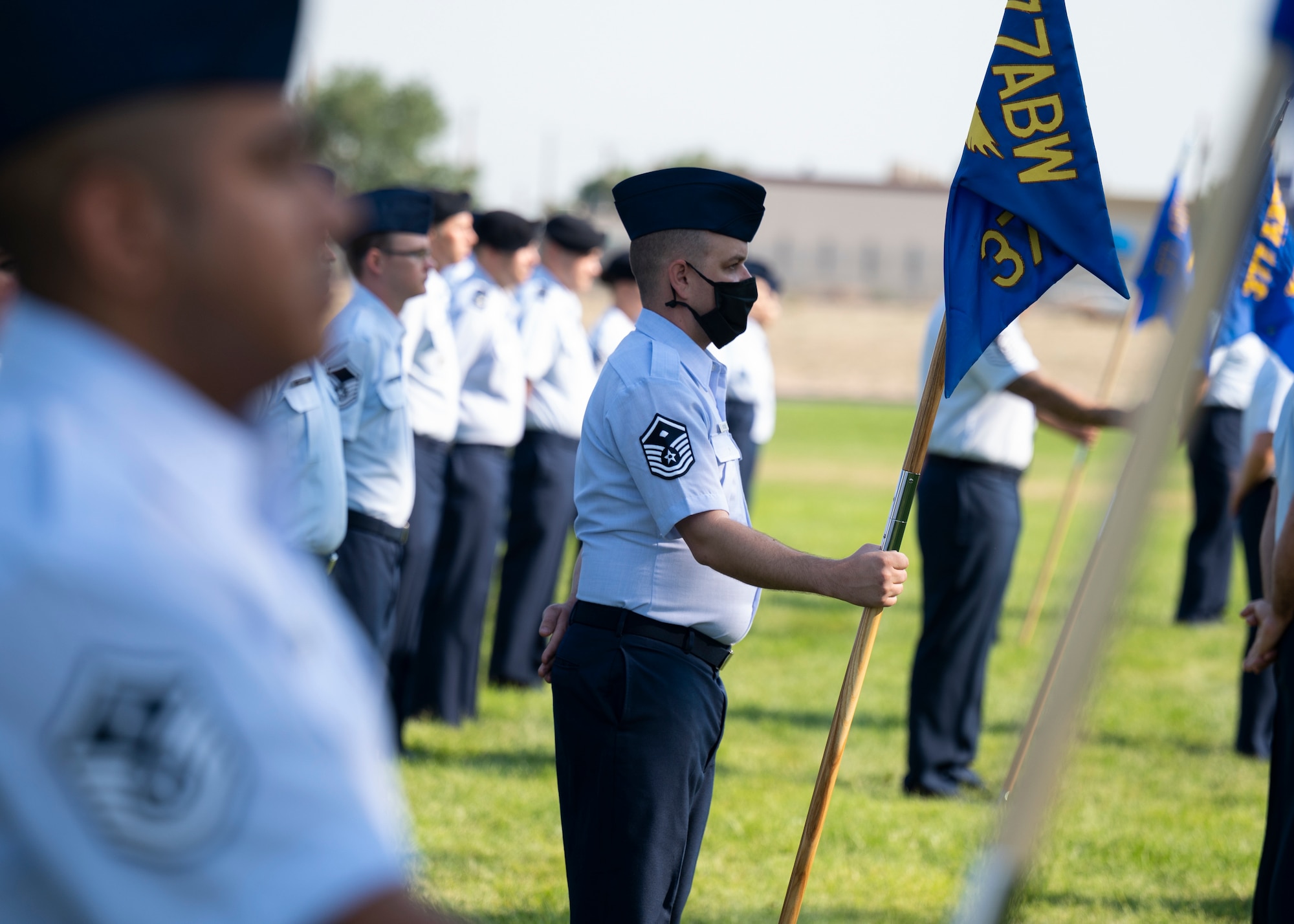 U.S. Air Force Master Sgt. Delbert R. Butcher holds a guidon.