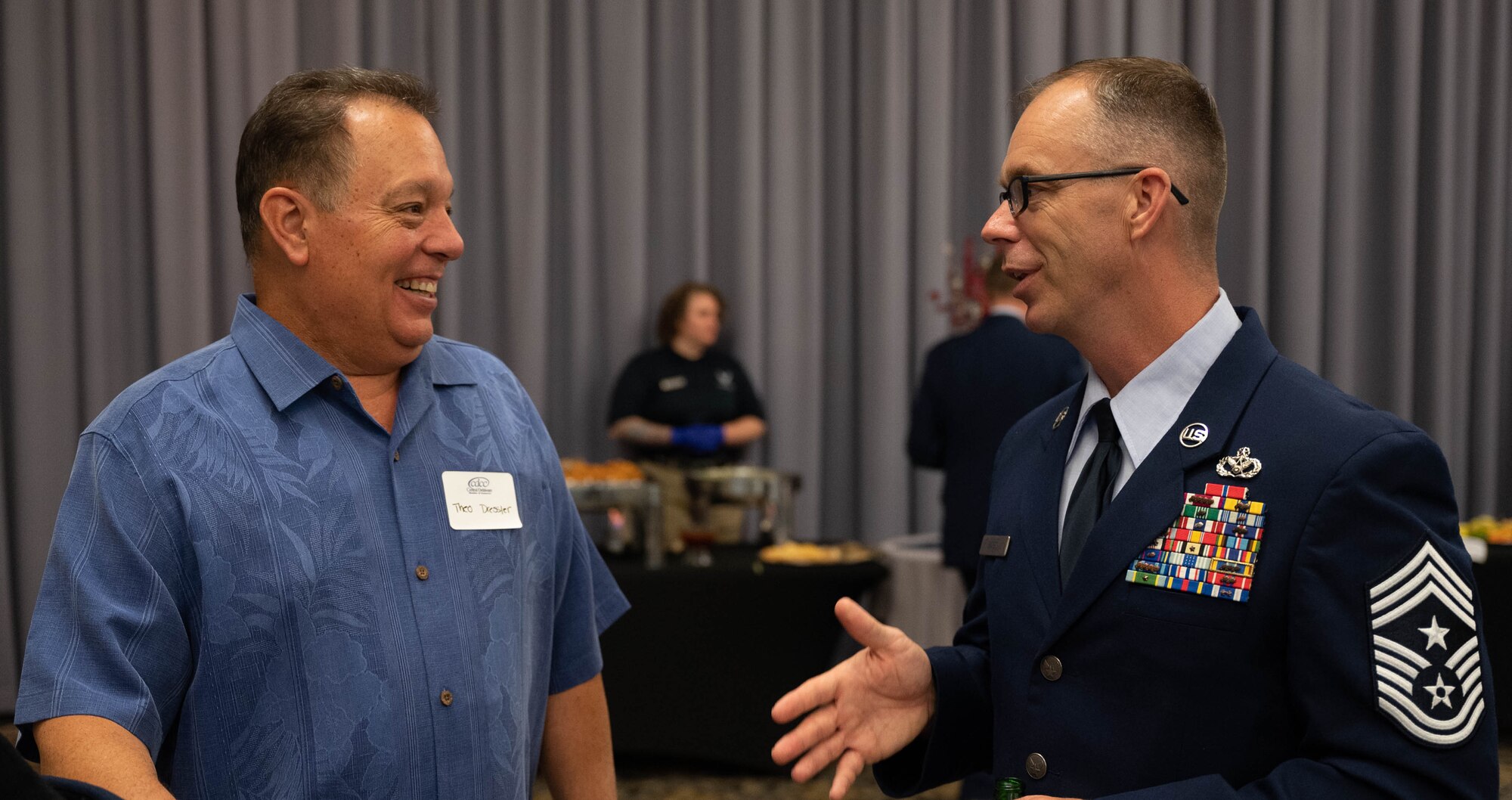 Theo Dressler, left, Dressler Asset Management and Financial Planning financial advisor, speaks with Chief Master Sgt. Timothy Bayes, 436th Airlift Wing command chief, during the Military Affaire event at Dover Air Force Base, Delaware, June 17, 2021. The annual event brings Dover AFB and community leaders together to network and build relationships. (U.S. Air Force photo by Senior Airman Faith Schaefer)