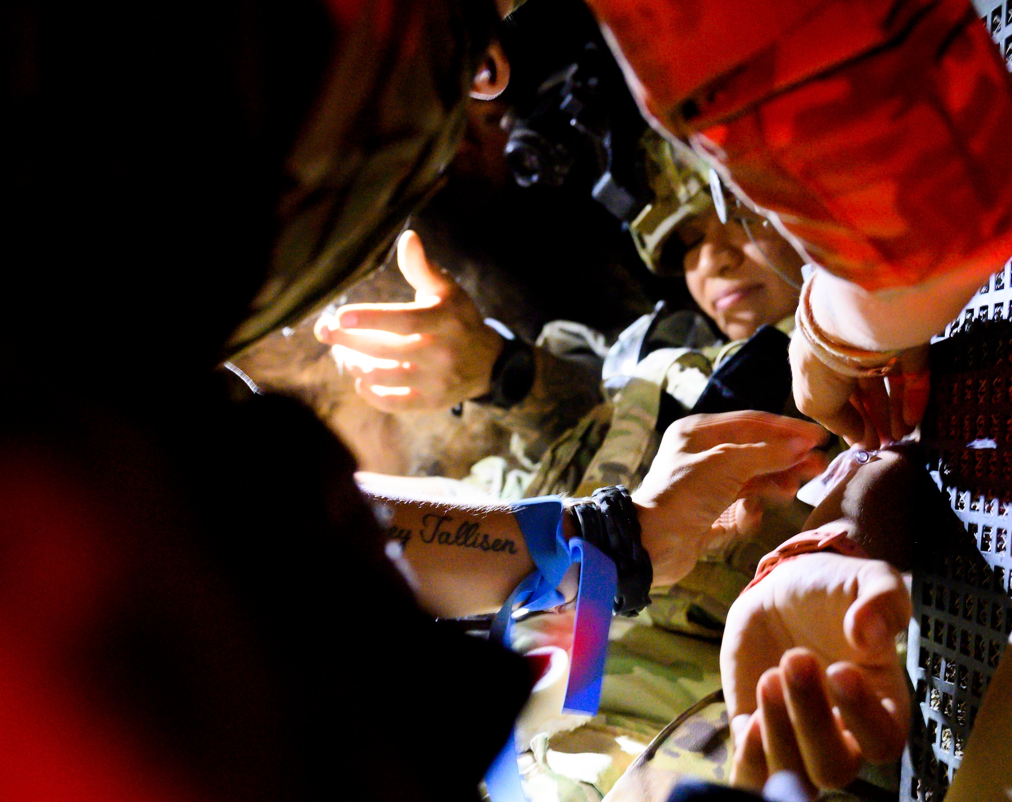 U.S. Air Force Staff Sgt. Maria Delgadillo, a military working dog handler with the 378th Expeditionary Security Forces Squadron, and her MWD, Rony, receive medical care during a quick response training event in blackout conditions at Prince Sultan Air Base, Kingdom of Saudi Arabia, June 12, 2021. PSAB Explosive Ordnance Disposal, Security Forces and Medical personnel participated in integrated training to bolster defensive capabilities and maintain readiness at all times. (U.S. Air Force photo by Senior Airmen Samuel Earick)