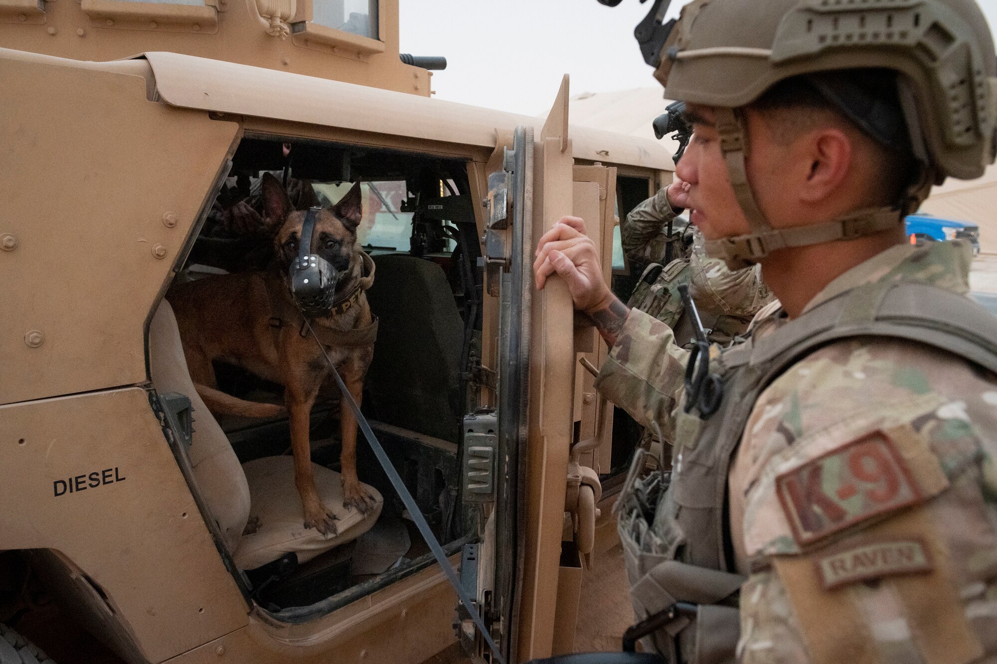 U.S. Air Force Staff Sgt. Kane Smoot, military working dog handler with the 378th Expeditionary Security Forces Squadron, and his MWD, Iisolda, prepare for a quick response training event in blackout conditions at Prince Sultan Air Base, Kingdom of Saudi Arabia, June 12, 2021. PSAB Explosive Ordnance Disposal, Security Forces and Medical personnel participated in integrated training to bolster defensive capabilities and maintain readiness at all times. (U.S. Air Force photo by Staff Sgt. Caleb Pavao)