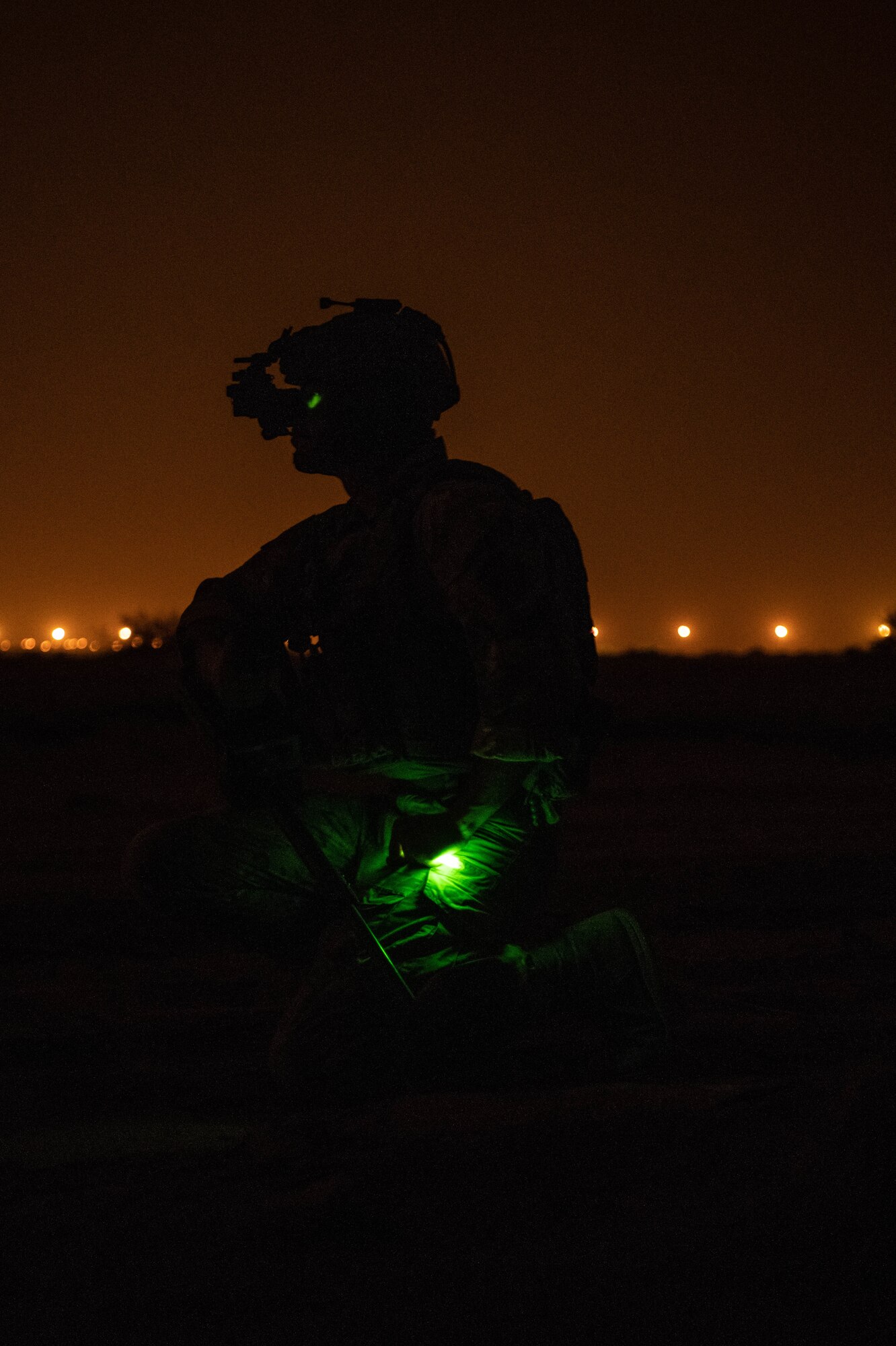 U.S. Air Force Staff Sgt. Gideon Hanes, 378th Expeditionary Civil Engineer Squadron Explosive Ordnance Disposal team lead, pauses to survey the road ahead while searching for simulated improvised explosive devices during a quick response training event in blackout conditions at Prince Sultan Air Base, Kingdom of Saudi Arabia, June 12, 2021. PSAB EOD, Security Forces and Medical personnel participated in integrated training to bolster defensive capabilities and maintain readiness at all times. (U.S. Air Force photo by Capt. Rachel Buitrago)