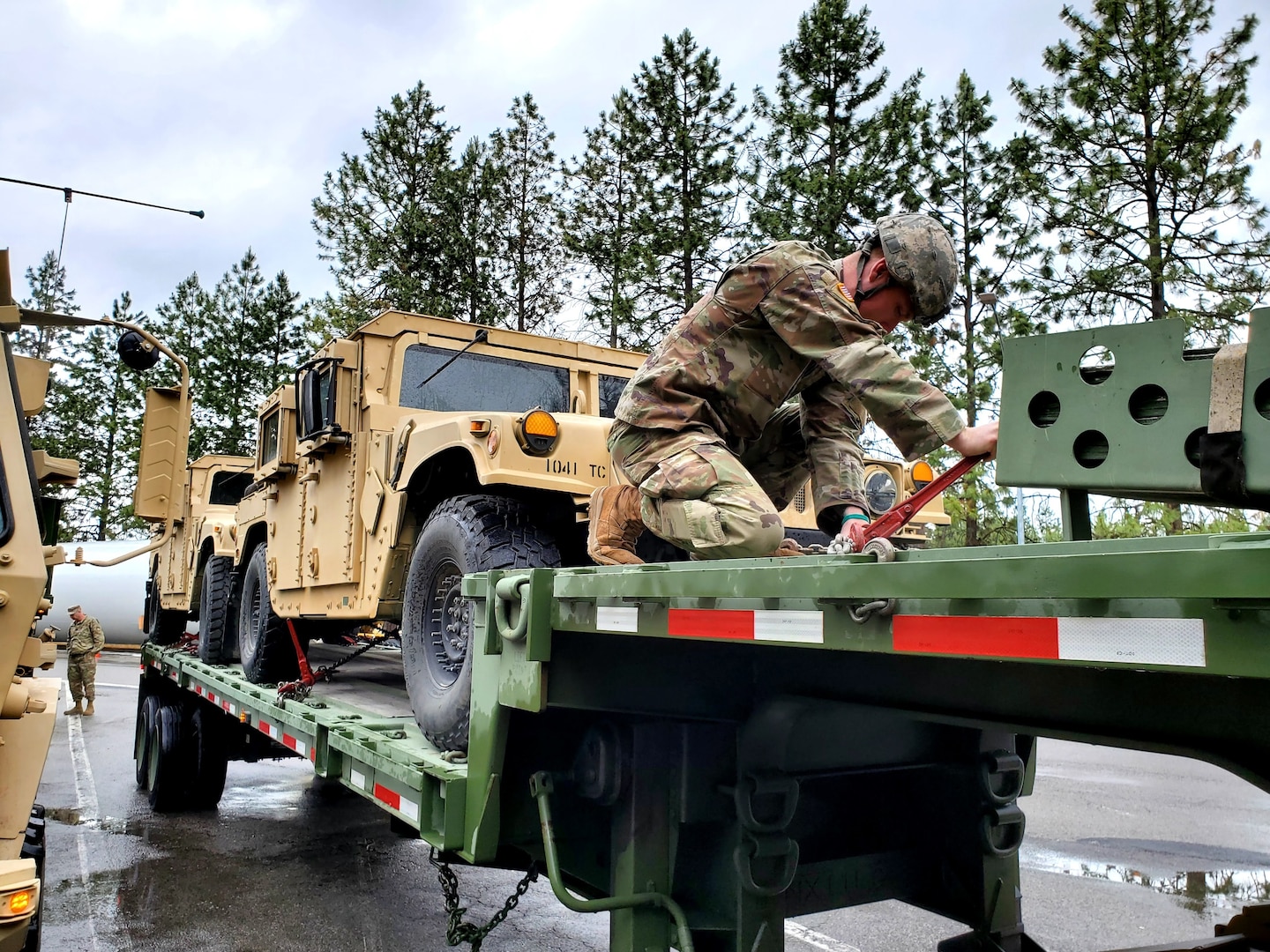 A Washington National Guard member of the 1041st Transportation Company ensures equipment is tied down before departing Fairchild Air Force Base, Wash., June 7, 2021, for annual training at Fort Harrison, Montana.