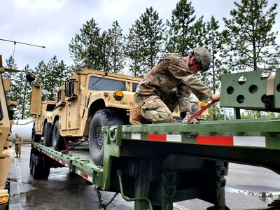 A Washington National Guard member of the 1041st Transportation Company ensures equipment is tied down before departing Fairchild Air Force Base, Wash., June 7, 2021, for annual training at Fort Harrison, Montana.