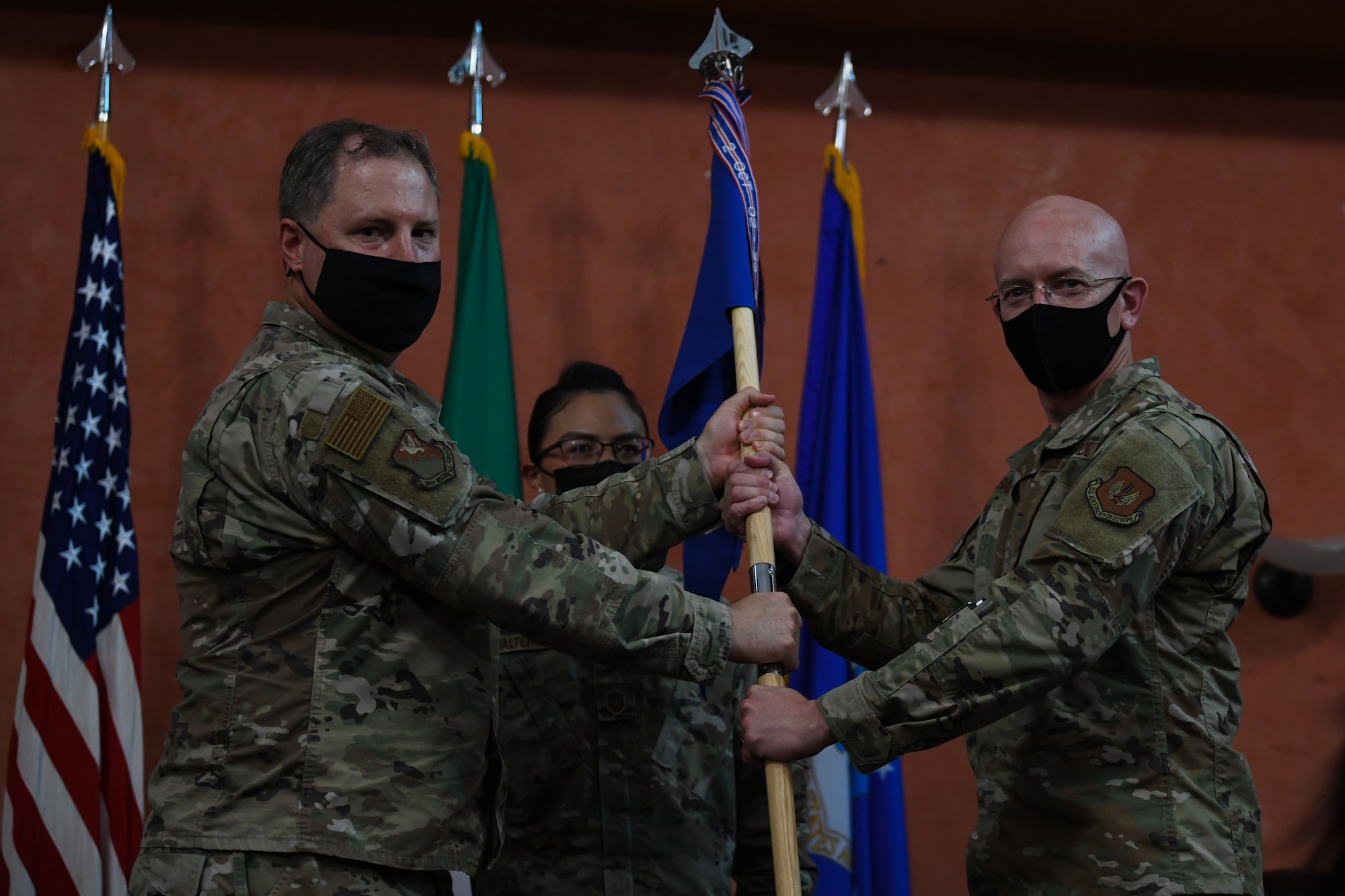 U.S. Air Force Col. Wade Adair, 31st Medical Group commander, left, passes the guidon to U.S. Col. Cade Salmon 31st Dental Squadron incoming commander, at Aviano Air Base, Italy, June 22, 2021. The 31st DS consists of three flights, including Clinical Dentistry, Dental Support and Dental Laboratory. (U.S. Air Force photo by Airman First Class Taryn Onyon)