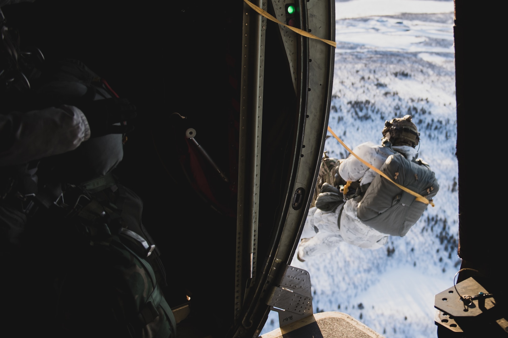 A U.S. Tactical Air Control Party Airman assigned to the 2nd Air Support Operations Squadron, Vilseck, Germany, jumps out of a C-130J Super Hercules over Kiruna, Sweden, prior to Exercise Cold Response 20, Feb. 27, 2020. Photo by Staff Sgt. Devin Boyer.