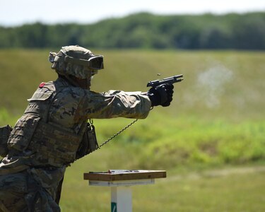 A Soldier with the 1776th Military Police Company, Michigan Army National Guard, conducts M9 pistol qualification during annual training at Fort Custer Training Center, Augusta, Michigan, June 16, 2021.