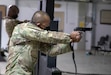 Sgt. Jason E. Javier, a veterinary food inspection noncommissioned officer with 993rd Medical Detachment 3rd Medical Command, engages his targets during a weapons event for the U.S. Army Central 2021 Best Warrior Competition at Camp Arifjan, Kuwait, June 22, 2021. The competitors conducted various weapons qualification using the Engagement Skills Trainer II as part of the event.(U.S. Army photo by Staff Sgt. True Thao, U.S. Army Central Public Affairs)