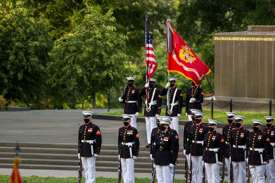 Marines with the Official Marine Corps Color Guard stand at the position of attention during a Tuesday Sunset Parade at the Marine Corps War Memorial, Arlington, VA, June 23, 2021. Major Gen. Julian D. Alford, commanding general, Training Command, was the hosting official and Dr. Salim Lala, assistant professor of surgery, Division of Vascular Surgery – Department of Surgery, the GW Medical Facility Associates, Washington D.C., was the guest of honor. (U.S. Marine Corps photo by Lance Cpl. Tanner Lambert)