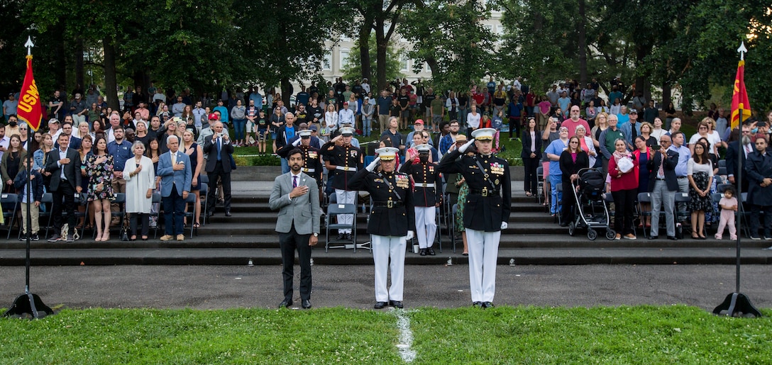 Dr. Salim Lala, assistant professor of surgery, Division of Vascular Surgery – Department of Surgery, the GW Medical Facility Associates, Washington D.C., Maj. Gen. Julian D. Alford, commanding general, Training Command, center, and Col. Teague A. Pastel, commanding officer, Marine Barracks Washington, right, stand at the position of attention for “honors” during a Tuesday Sunset Parade at the Marine Corps War Memorial, Arlington, VA, June 23, 2021. Major Gen. Alford was the hosting official and Dr. Lala, was the guest of honor. (U.S. Marine Corps photo by Lance Cpl. Mark Morales)