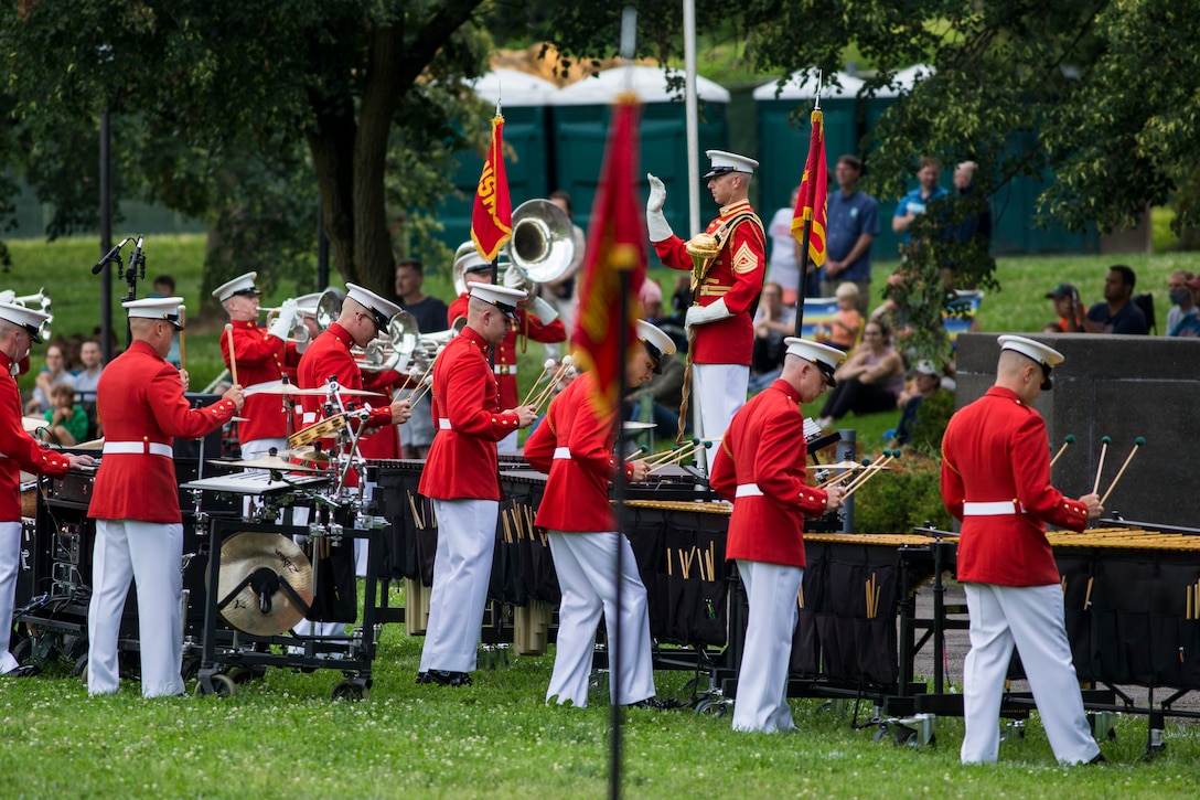 Marines with “The Commandant’s Own,” U.S. Marine Drum and Bugle Corps perform during a Tuesday Sunset Parade at the Marine Corps War Memorial, Arlington, VA, June 23, 2021. Major Gen. Julian D. Alford, commanding general, Training Command, was the hosting official and Dr. Salim Lala, assistant professor of surgery, Division of Vascular Surgery – Department of Surgery, the GW Medical Facility Associates, Washington D.C., was the guest of honor. (U.S. Marine Corps photo by Lance Cpl. Tanner Lambert)