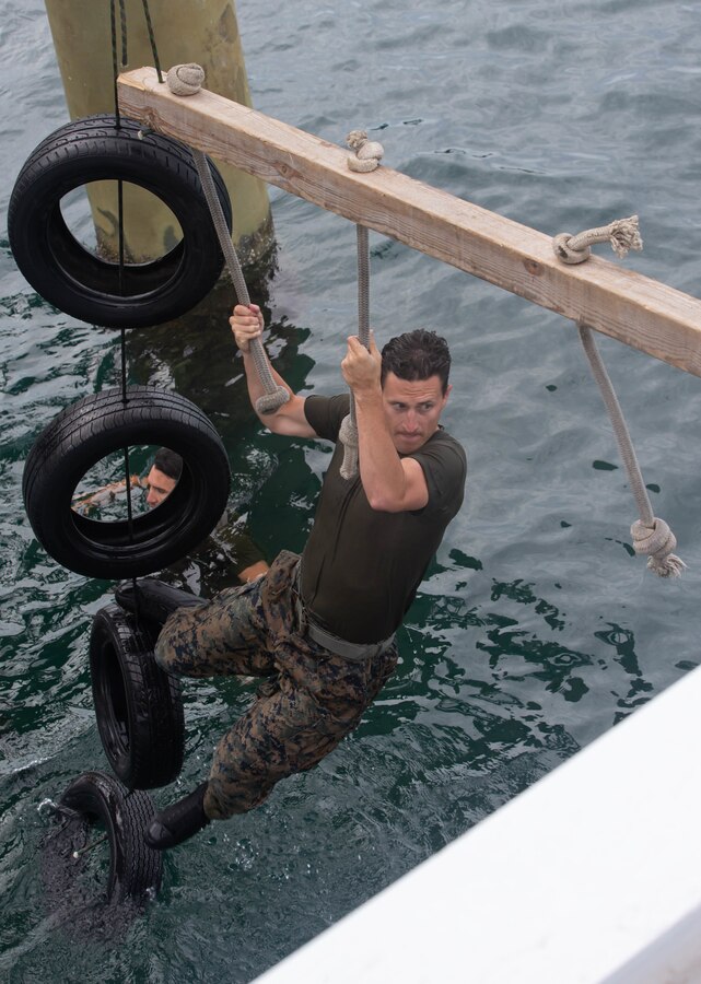 U.S. Marine Corps Capt. Mitchell Moore, a native of Carmel, Ind., platoon commander with 2d Reconnaissance Battalion (2d Recon), 2d Marine Division, participates in a water obstacle during Exercise Caribbean Coastal Warrior on Savaneta Kamp, Aruba, June 18, 2021.