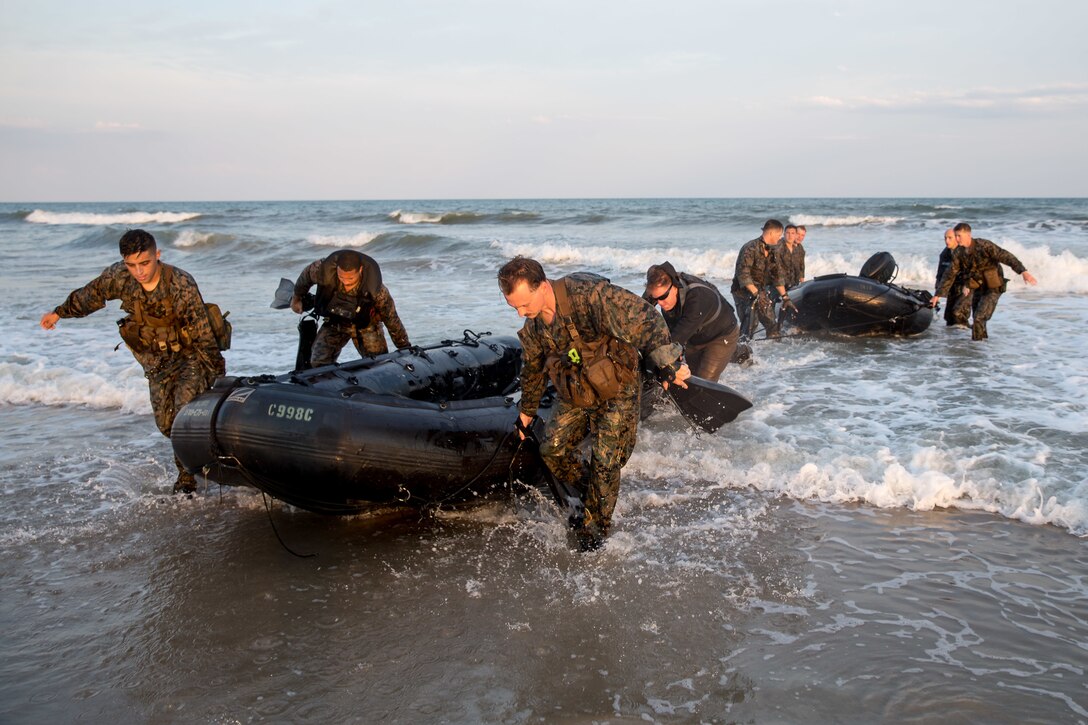 U.S. Marines with Bravo Company, 2d Reconnaissance Battalion, 2d Marine Division, bring ashore a Combat Rubberized Raiding Craft during an air to sea insertion training event on Camp Lejeune, N.C., June 16, 2021. The training established and refined the Marines’ standard operating procedures in amphibious insertions, extractions, and reconnaissance in preparation for Naval Large-Scale Exercise. (U.S. Marine Corps photo by Cpl. Elijah J. Abernathy)