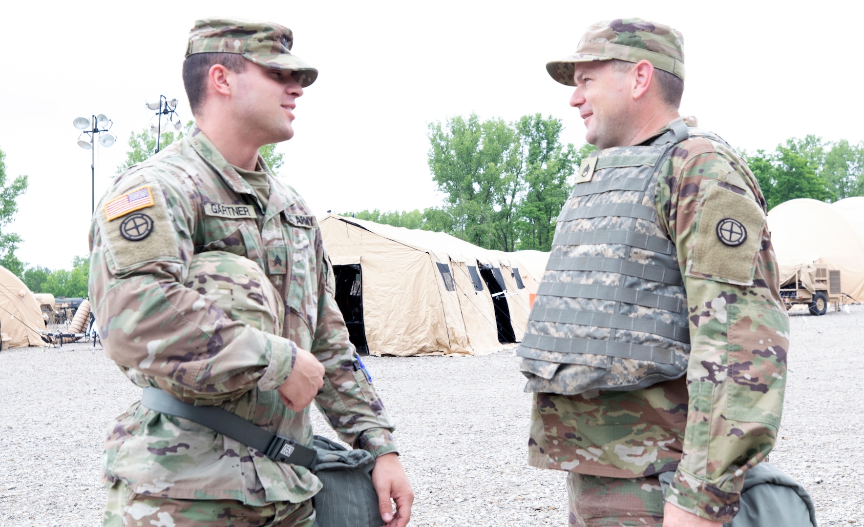 Sgt. Ryan Gartner and Staff Sgt. Brian Foley, both of the 35th Infantry Division, take time to go over their job duties for the day June 9, 2021, during Warfighter 21-05 at Camp Atterbury, Ind.