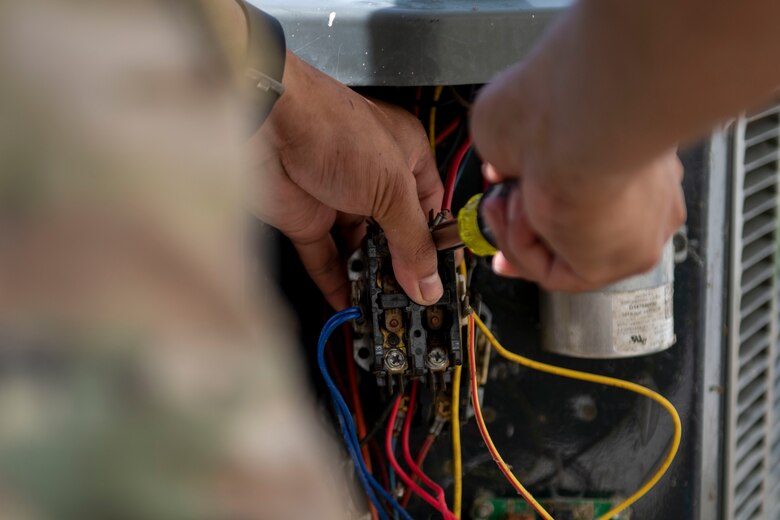 Senior Airman Joje Masaganda, 4th Civil Engineer Squadron heating, ventilation, air conditioning and refrigeration technician, changes out the contactor on a split system air conditioning unit at Seymour Johnson Air Force Base, North Carolina, June 14, 2021.