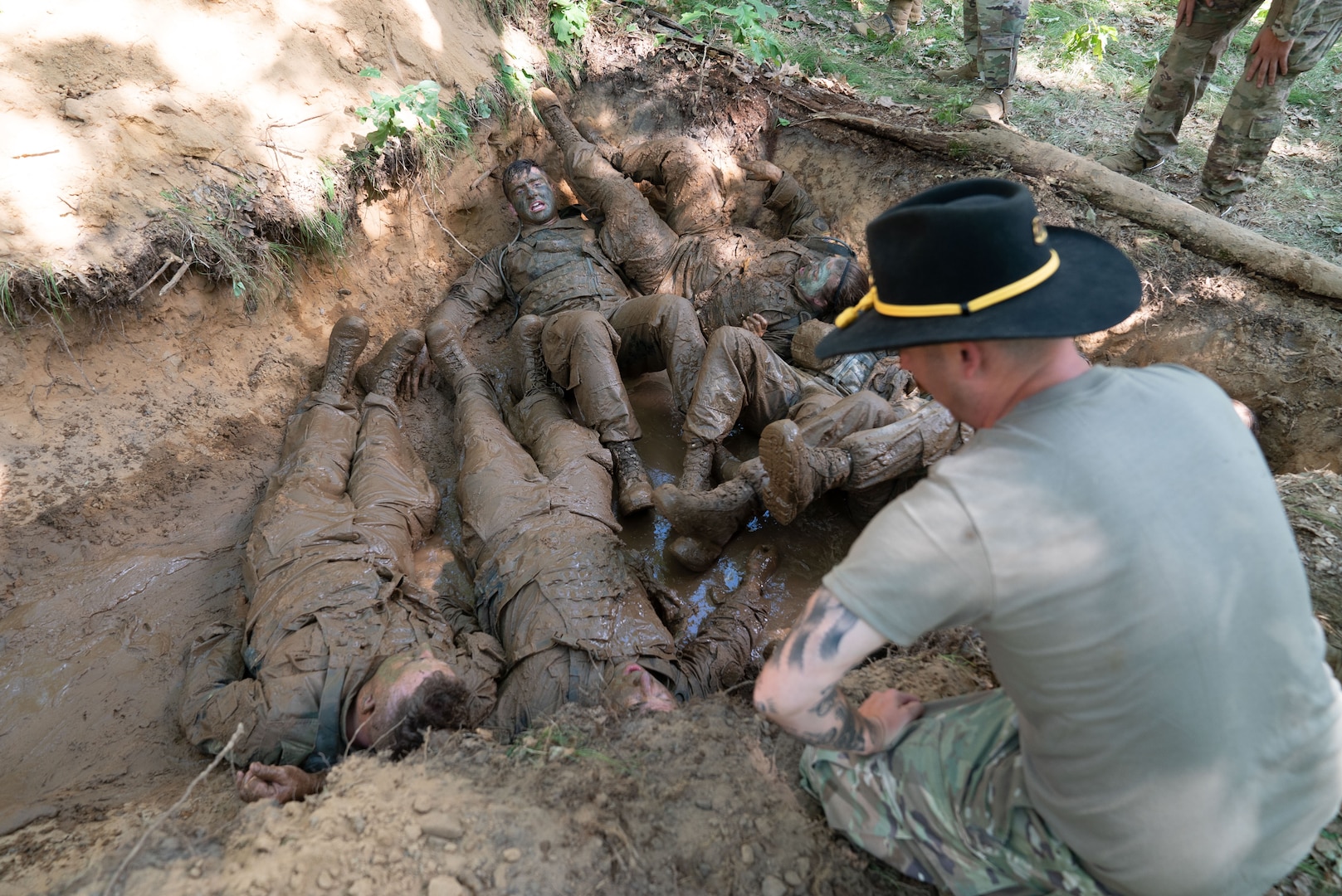 After crawling through a muddy trench, Soldiers in the Wisconsin Army National Guard’s 1st Squadron, 105th Cavalry, are quizzed on cavalry knowledge as part of a voluntary qualification course known as a spur ride June 15, 2021, at Fort McCoy. Cavalry troopers who successfully complete the ride earn their spurs.