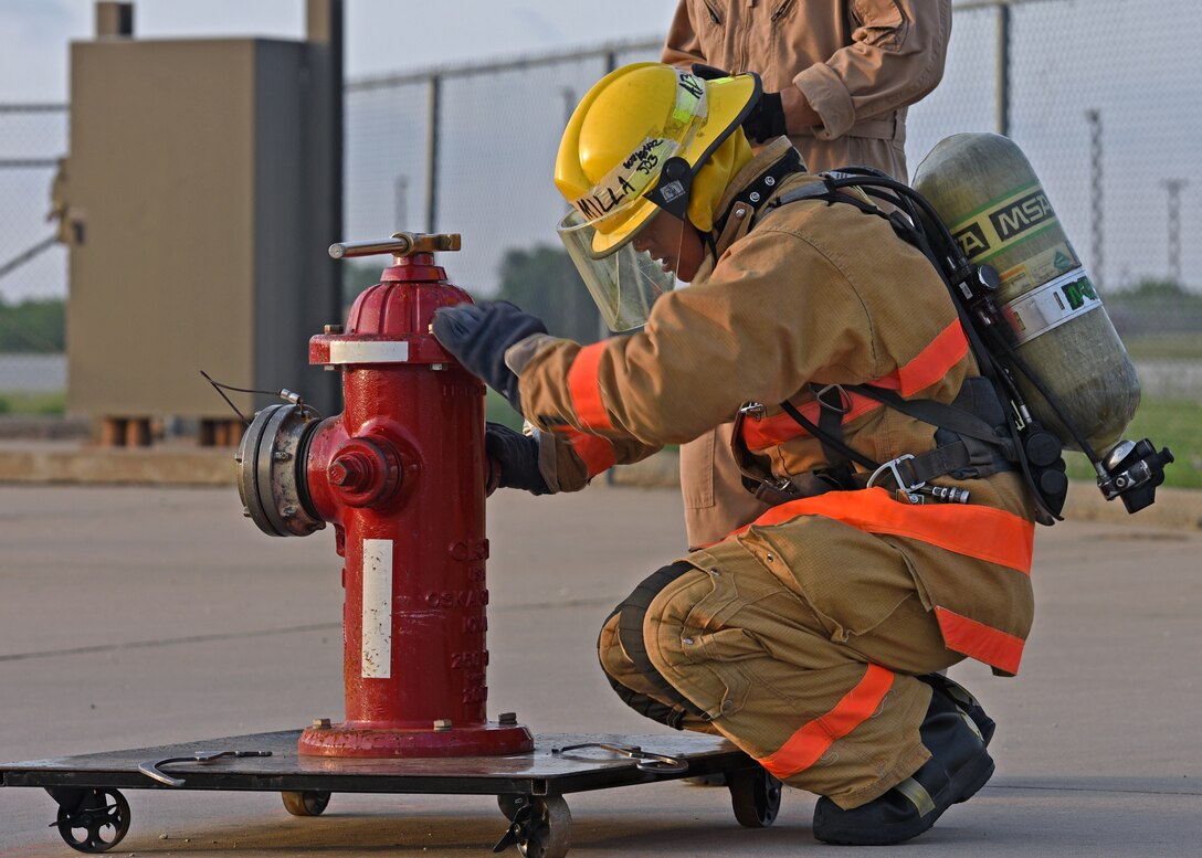 U.S. Navy Petty Officer 3rd Class Anthony Milla, 312th Training Squadron student, operates a fire hydrant during a training on Goodfellow Air Force Base, Texas, June 11, 2021. Milla trained in a joint environment with students from U.S and allied military services. (U.S. Air Force photo by Senior Airman Abbey Rieves)