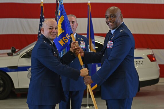 U.S. Air Force Col. Andres Nazario, 17th Training Wing commander, passes the guidon to Col. Eugene Moore III, incoming 17th Mission Support Group commander, during the change of command ceremony on Goodfellow Air Force Base, Texas, June 23, 2021. Moore was previously the director of staff at Air University, Maxwell AFB, Alabama. (U.S. Air Force photo by Senior Airman Ashley Thrash)