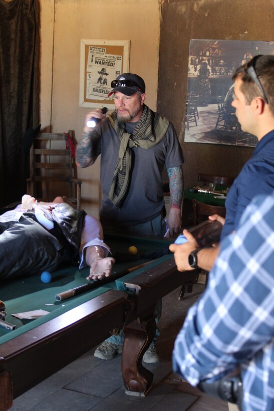 355th Security Forces Investigator Kyle Sitkowksi, left, and Office of Special Investigations, 12th Field Investigations Squadron Special Agent and Forensic Science Consultant Matthew Simonton, discuss the murder of Morgan Earp. They were part of a 23-member team participating in Crime Scene Training at the Mescal Movie set in Mescal, Ariz., where the 1993 Western, 'Tombstone' was shot. The unique venue provided period-correct clothing for the deceased, plus weapons and movie props to create the feel and atmosphere of the Old West. (Photo by William Hoffmann)