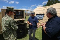 JOINT BASE LANGLEY-EUSTIS, Va. (June 23, 2021) HDT Global Logistics and Service Specialist Kyle Rinehart, middle, instructs Joint Task Force Civil Support personnel on how to operate and maintain a mobile diesel generator during Exercise Lightning Response on Fort Eustis, Virginia, June 23, 2021.