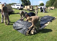 JOINT BASE LANGLEY-EUSTIS, Va. (June 23, 2021) Joint Task Force Civil Support incident support team personnel unroll an airbeam shelter during Exercise Lightning Response on Fort Eustis, Virginia, June 23, 2021.