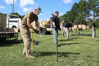 JOINT BASE LANGLEY-EUSTIS, Va. (June 23, 2021) Frank Metille, a medical directorate representative assigned to Joint Task Force Civil Support, drives a stake used to support an airbeam shelter during Exercise Lightning Response on Fort Eustis, Virginia, June 23, 2021.