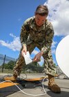 JOINT BASE LANGLEY-EUSTIS, Va. (June 23, 2021) Navy Information Systems Technician 1st Class Isaac Wilson, assigned to Joint Task Force Civil Support, plugs in a Starlink mobile satellite transceiver router during Exercise Lightning Response on Fort Eustis, Virginia, June 23, 2021.