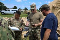 JOINT BASE LANGLEY-EUSTIS, Va. (June 23, 2021) U.S. Army Lt. Col. Mario Oliva, left, and Capt. Darren Hamby, middle, both Joint Task Force Civil Support incident support team leaders, take inventory of airbeam shelter and mobile generator  equipment and parts during Exercise Lightning Response on Fort Eustis, Virginia, June 23, 2021.