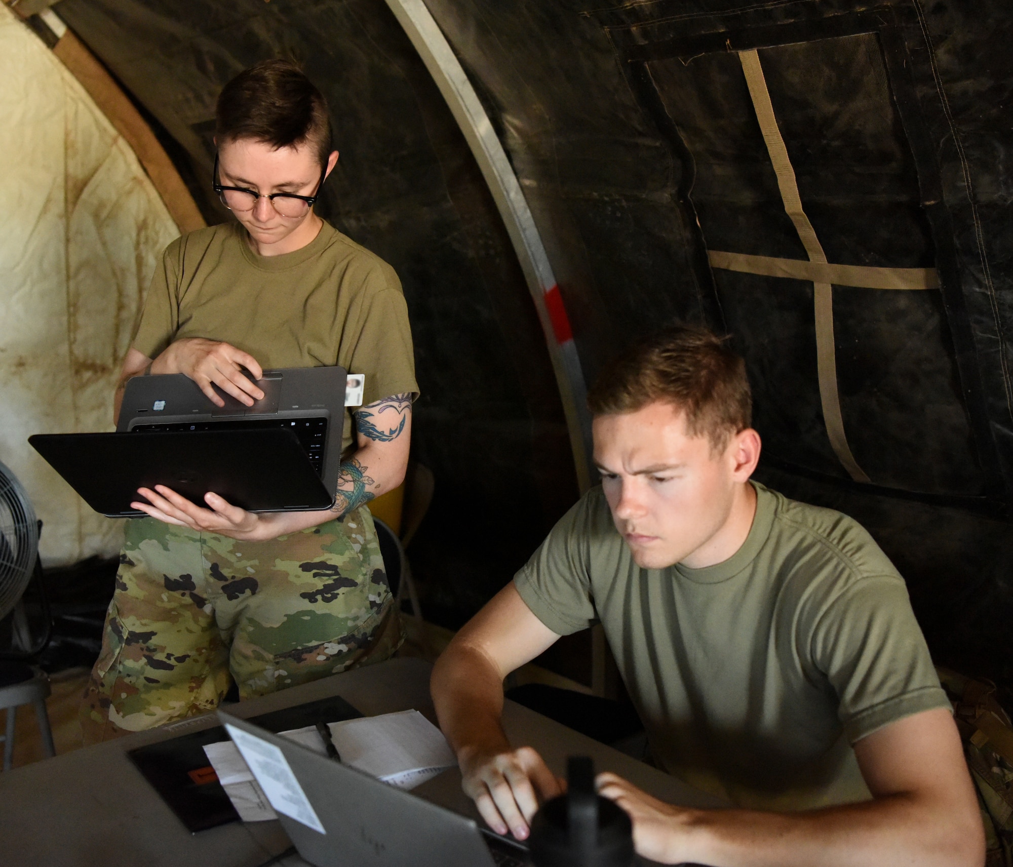 Airman 1st Class Hallie Collins, left, and 2nd Lt. Mitchell Wilcox, 56th Contracting Squadron contracting specialists  , conduct a training scenario during a Contingency Contracting Officer exercise June 9, 2021, at Luke Air Force Base, Arizona.