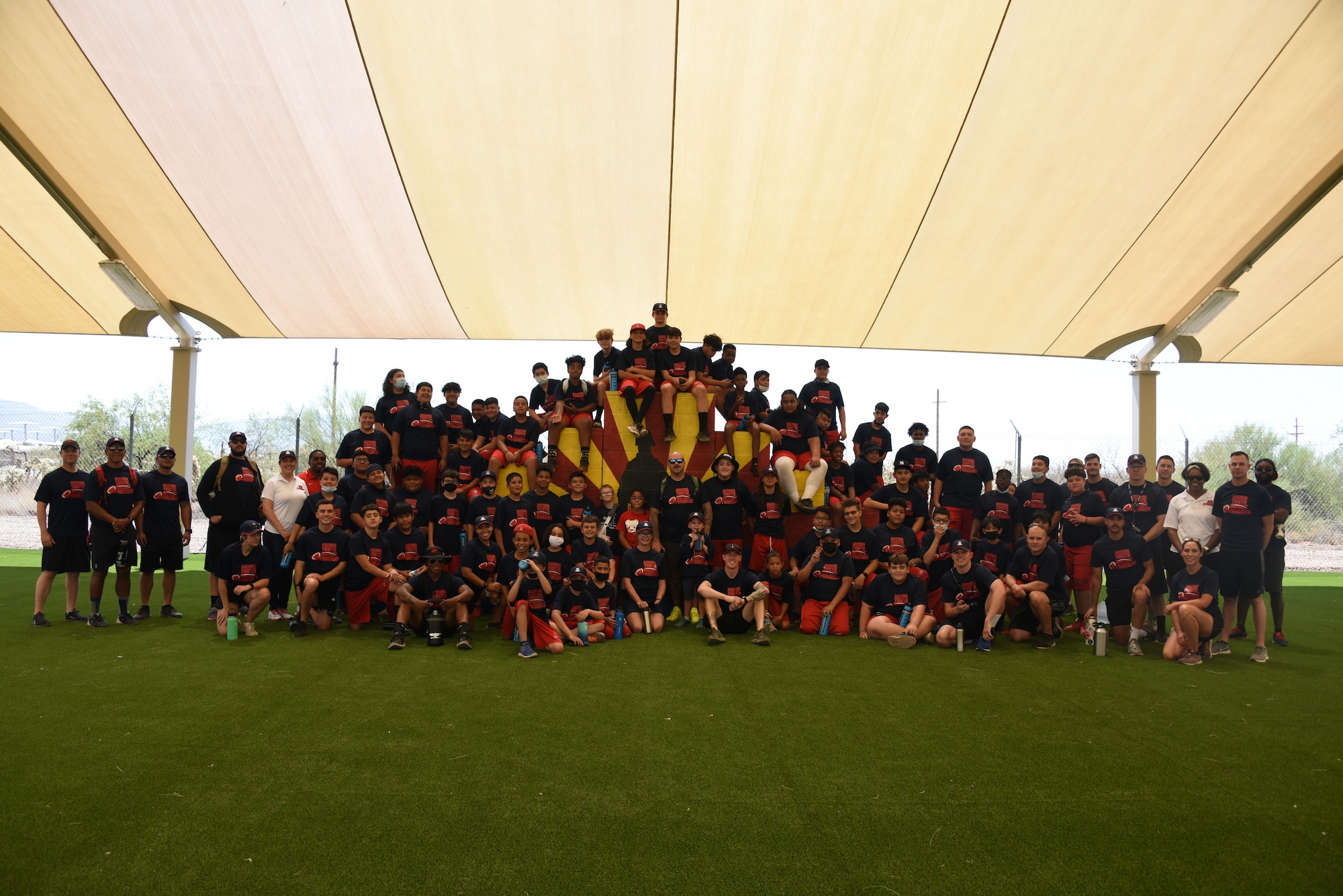 A photo of Children and staff gathered around for a group photo.
