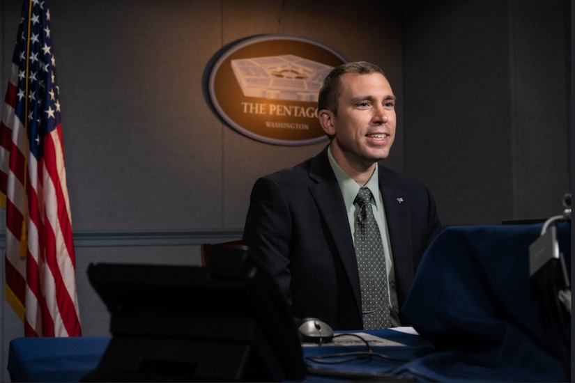 A man participates in a virtual meeting.