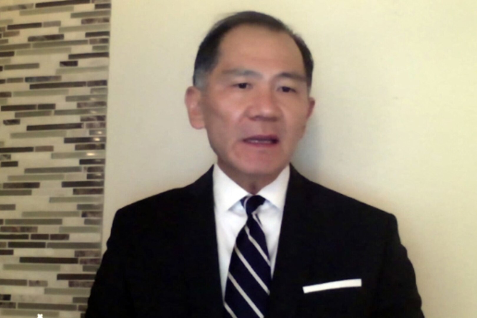 A man participates in a virtual meeting.