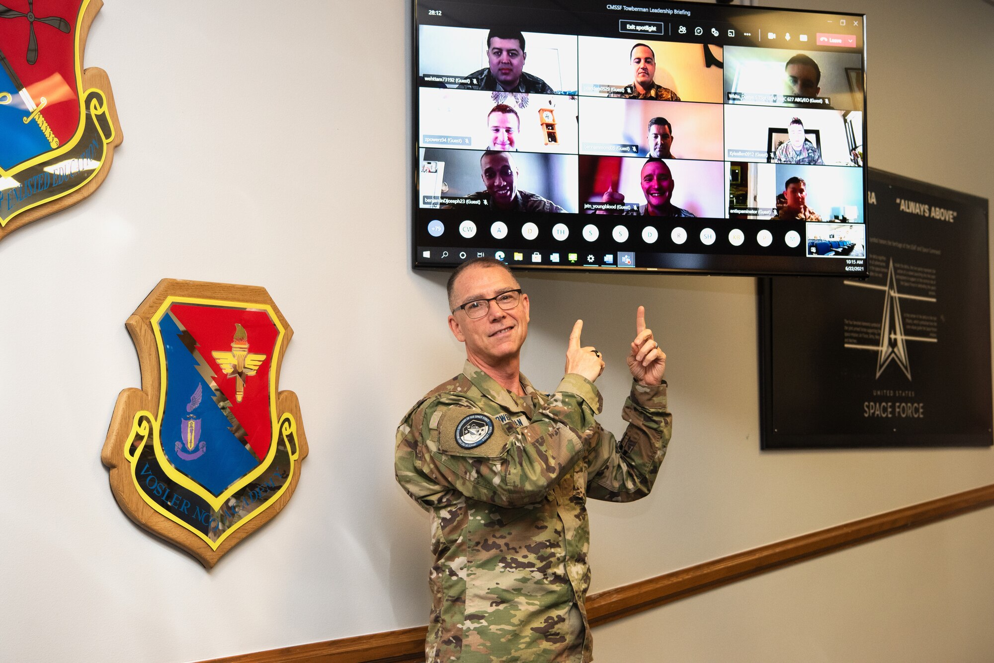 Chief Master Sgt. of the Space Force Roger A. Towberman poses with virtual members of the Vosler Non–Commissioned Officer Academy class at Peterson Air Force Base, Colorado, June 22, 2021. The NCOA curriculum prepares Airmen and Guardians to examine the impact of leadership and management actions and determine proper courses for achieving team goals. (U.S. Space Force photo by Airman 1st Class Joshua Fontenot)