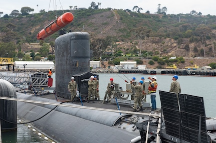 SAN DIEGO (June 22, 2021) Sailors load an inert encapsulated harpoon onto the the Los Angeles-class fast-attack submarine USS Scranton (SSN 756) The harpoon system provides commanders with lethal all-weather anti-ship capability to rapidly engage targets at long range. (U.S. Navy Photo by Mass Communication Specialist 2nd Class Thomas Gooley/Released)