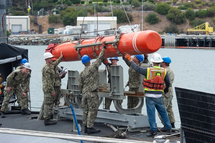 SAN DIEGO (June 22, 2021) Sailors load an inert encapsulated harpoon onto the the Los Angeles-class fast-attack submarine USS Scranton (SSN 756) The harpoon system provides commanders with lethal all-weather anti-ship capability to rapidly engage targets at long range. (U.S. Navy Photo by Mass Communication Specialist 2nd Class Thomas Gooley/Released)