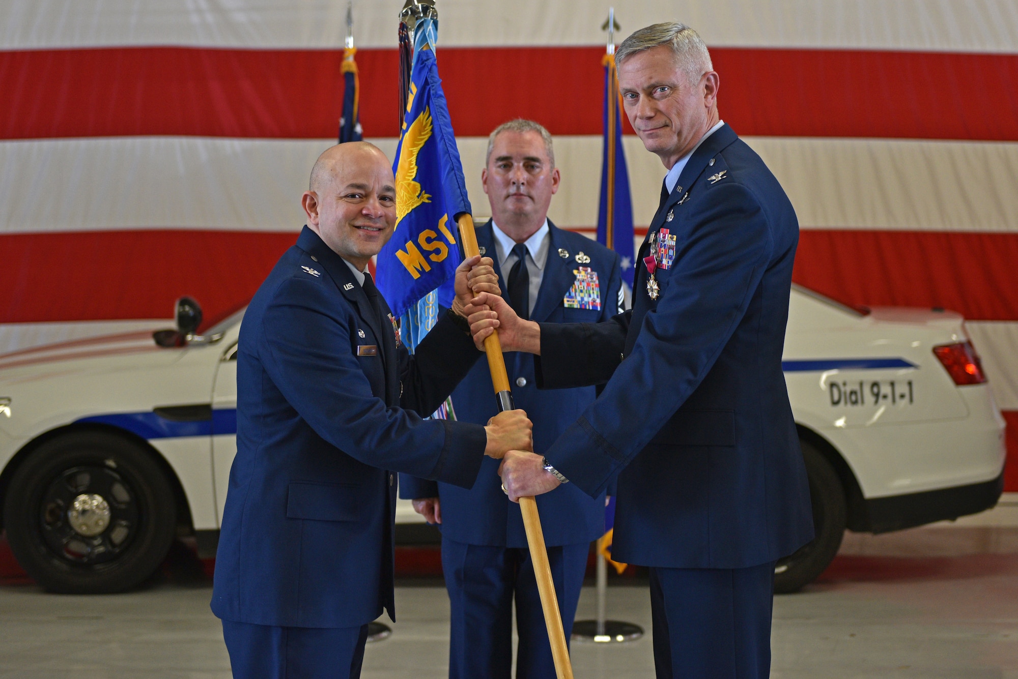 U.S. Air Force Col. Andres Nazario, 17th Training Wing commander, takes the guidon from Col. Tony England, outgoing 17th Mission Support Group commander, during the change of command ceremony on Goodfellow Air Force Base, Texas, June 23, 2021. England is taking a position at Pacific Air Forces Headquarters at Hickam AFB, Hawaii. (U.S. Air Force photo by Senior Airman Ashley Thrash)